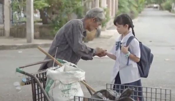 cụ già đang giúp đỡ bạn học sinh